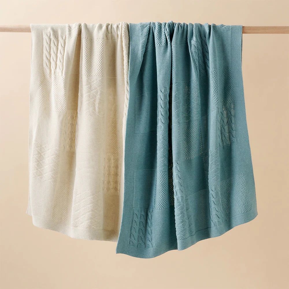 Green and neutral blankets hanging