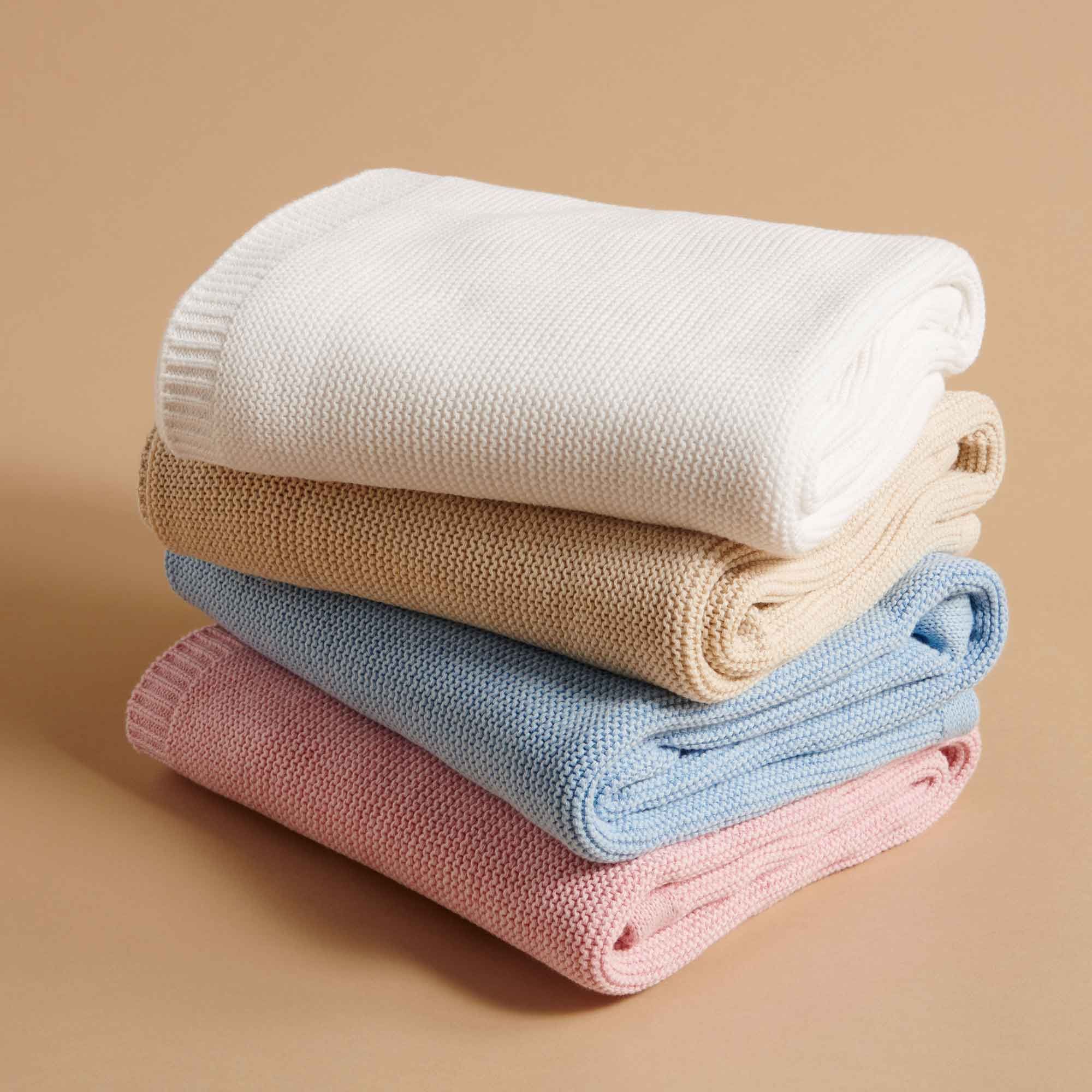 4 Purebaby knitted blankets folded and stacked