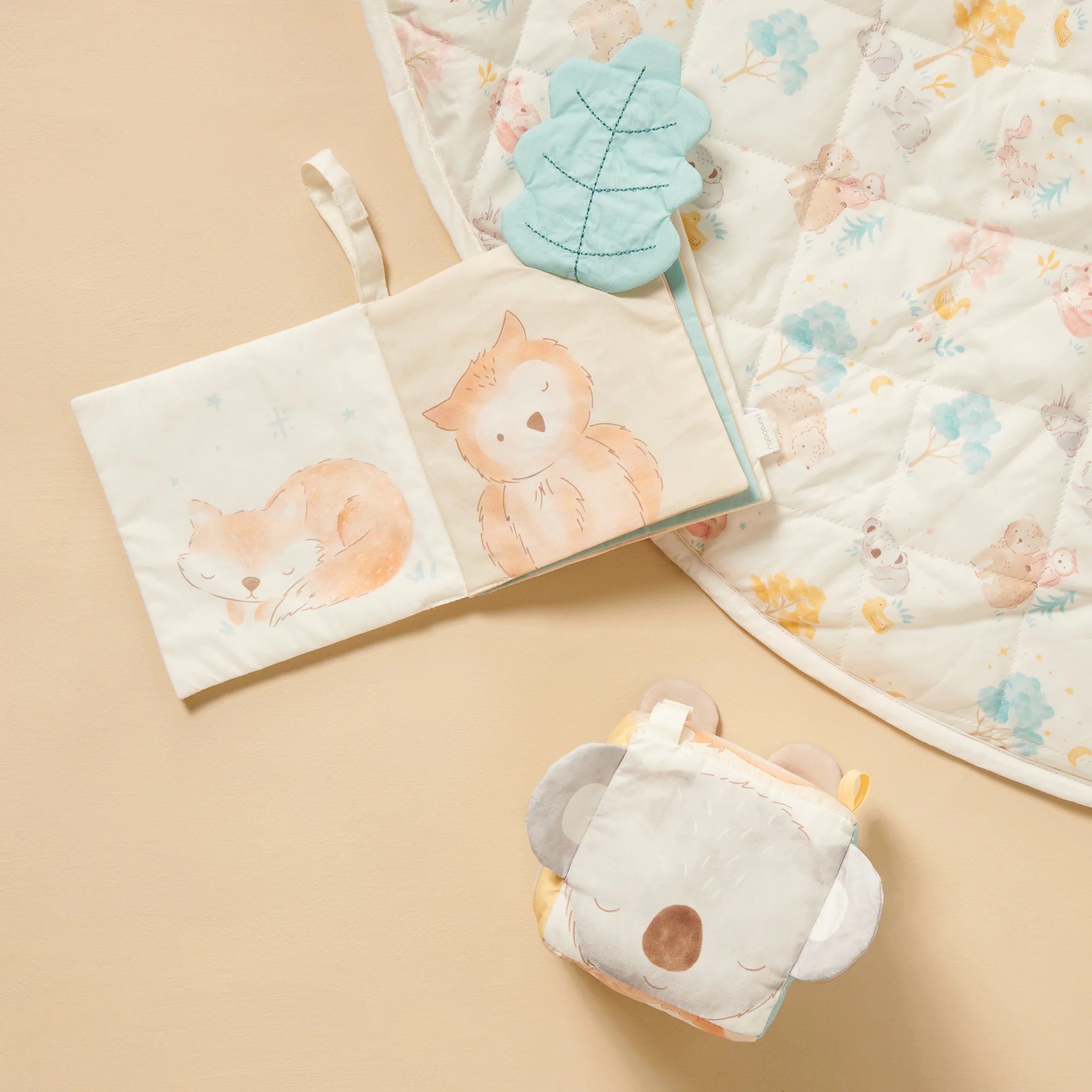 Sensory Play mat on ground with soft cube and soft book laying on top
