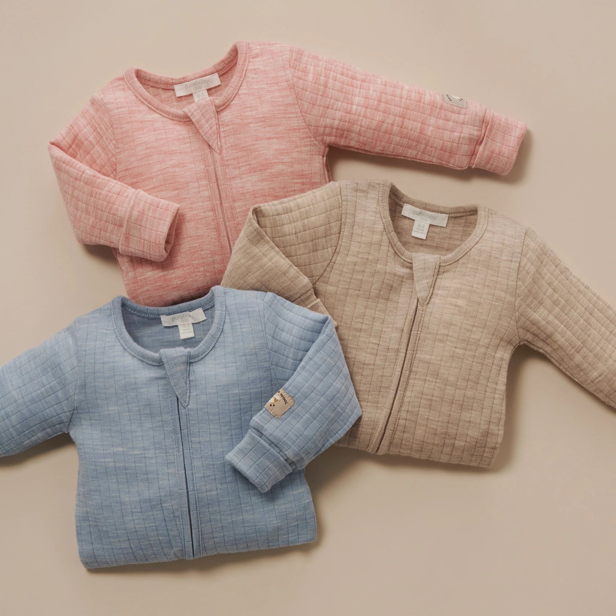 Merino Wool Growsuits folded up on ground together