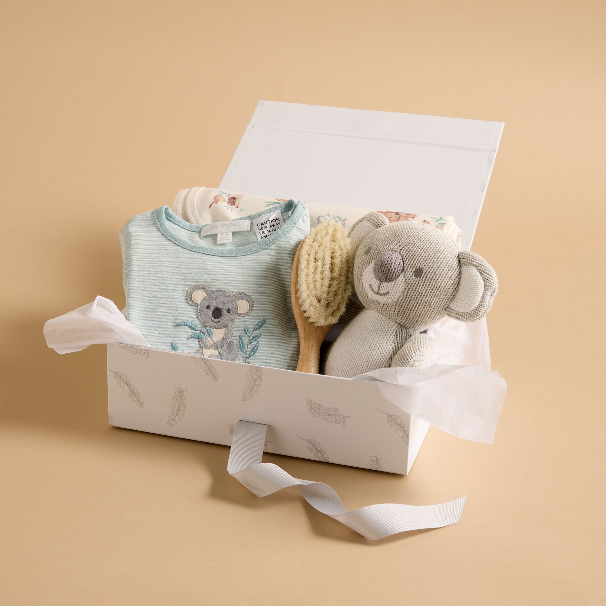 Gift box with Purebaby koala toy, growsuit and brush