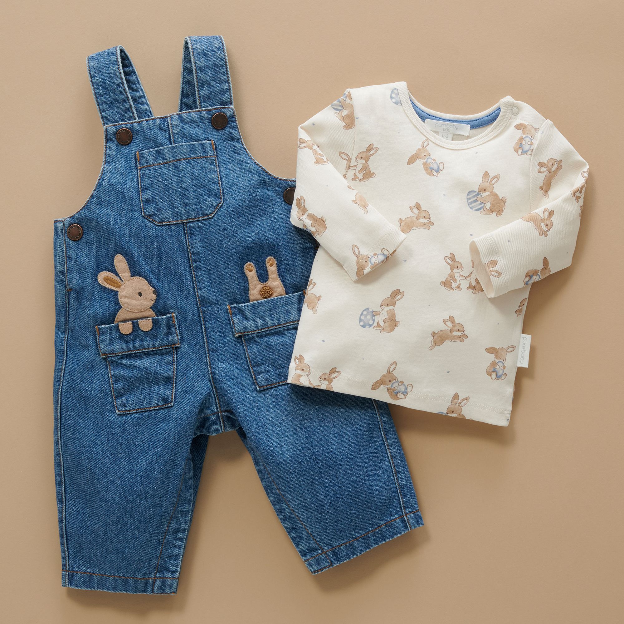 Bunny overalls laid out on paper