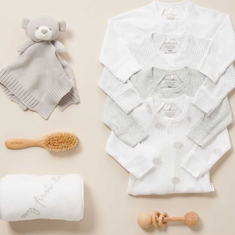 Purebaby growsuits, bear comforter, hair brush, wooden rattle and towel