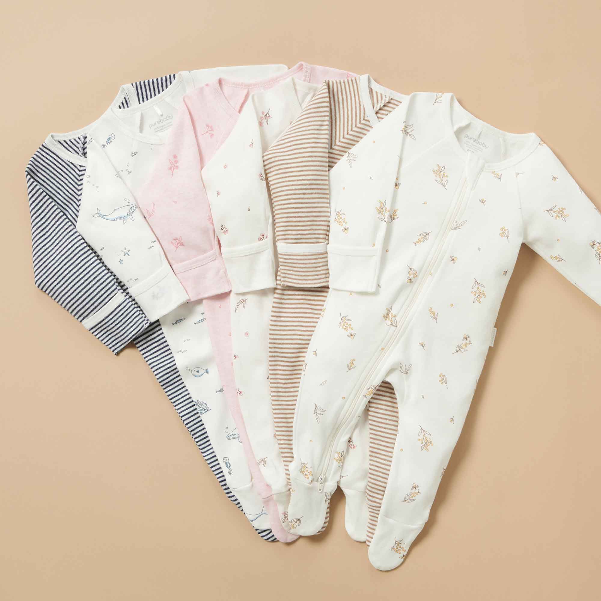 6 Purebaby growsuits in various prints and stripes