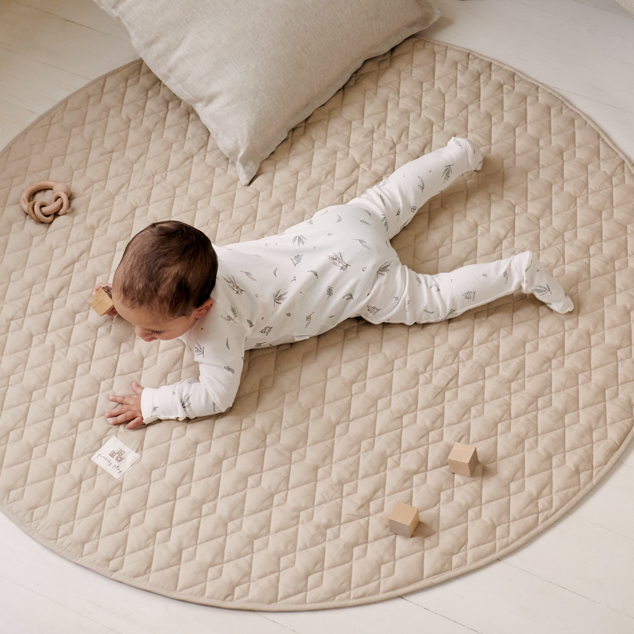 Baby laying on play mat